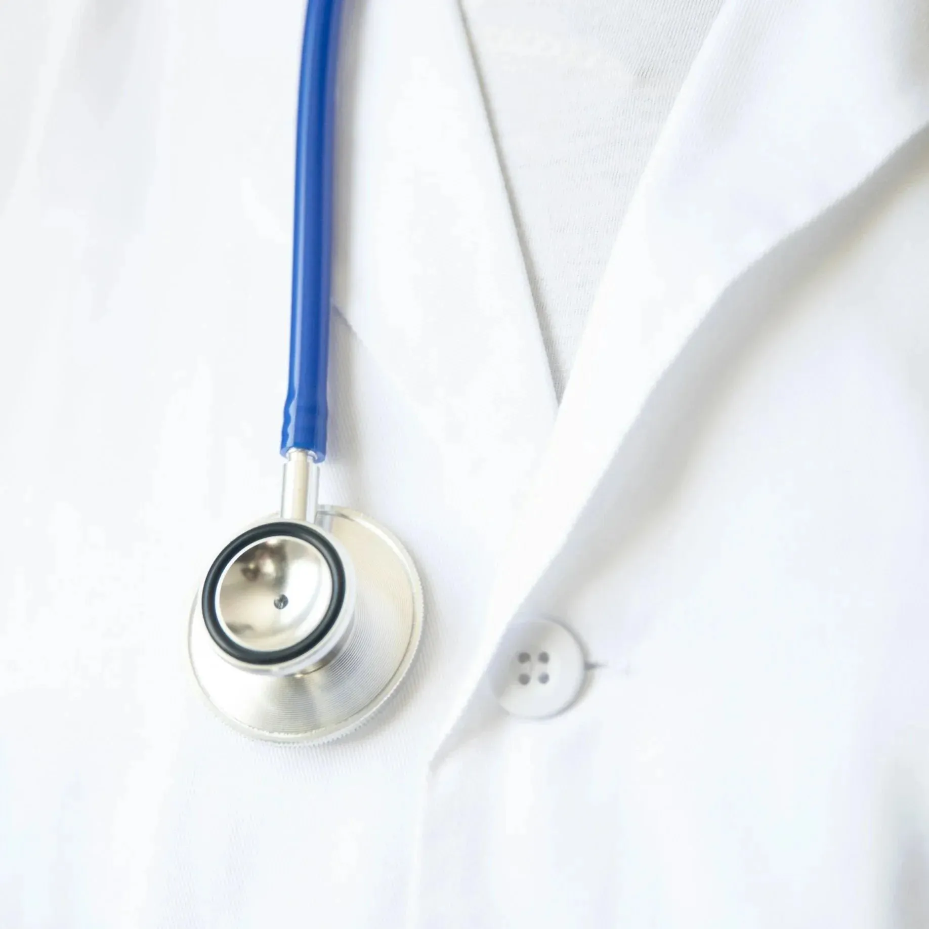 A stethoscope over a white coat