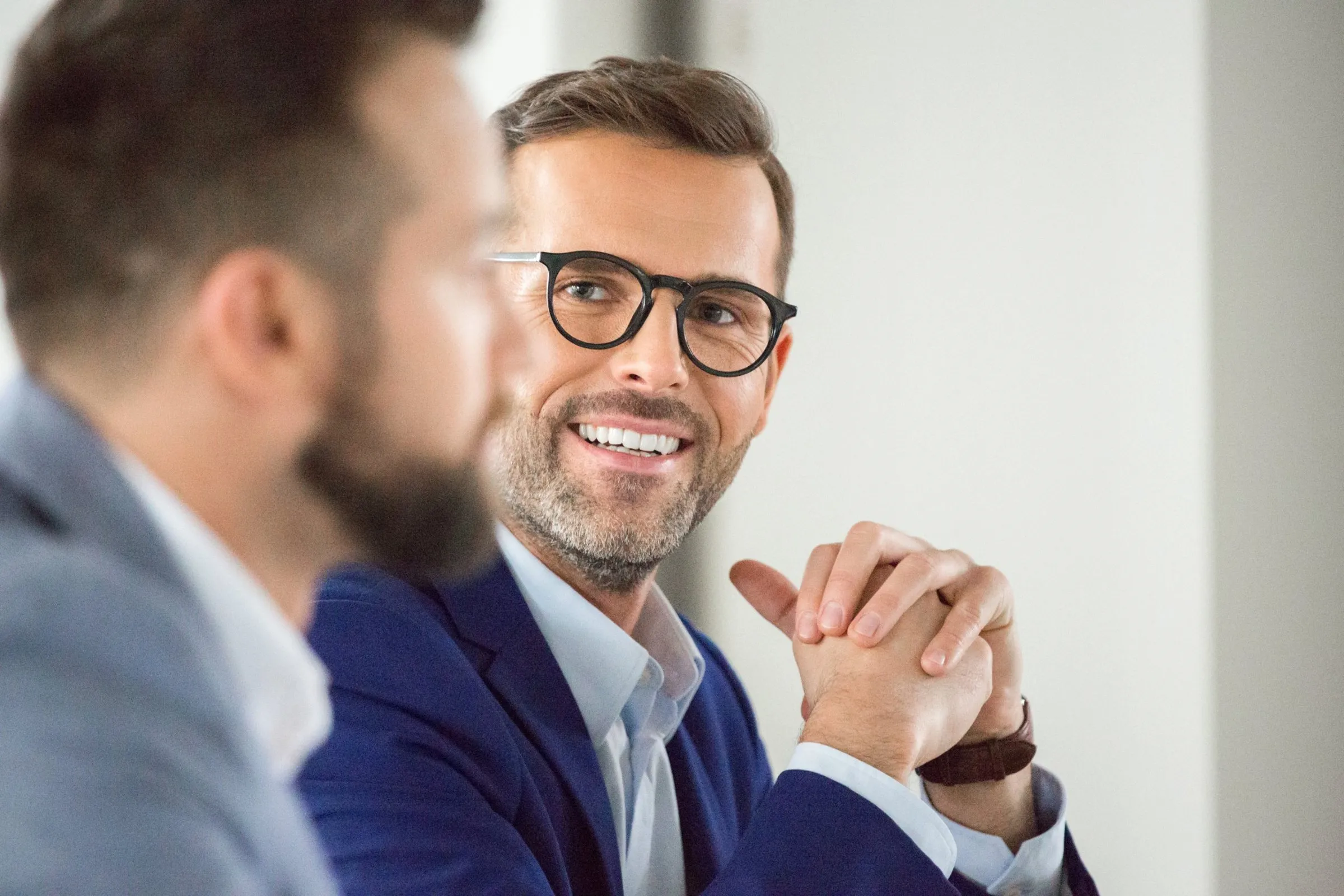 A smiling advisor in a meeting with a colleague